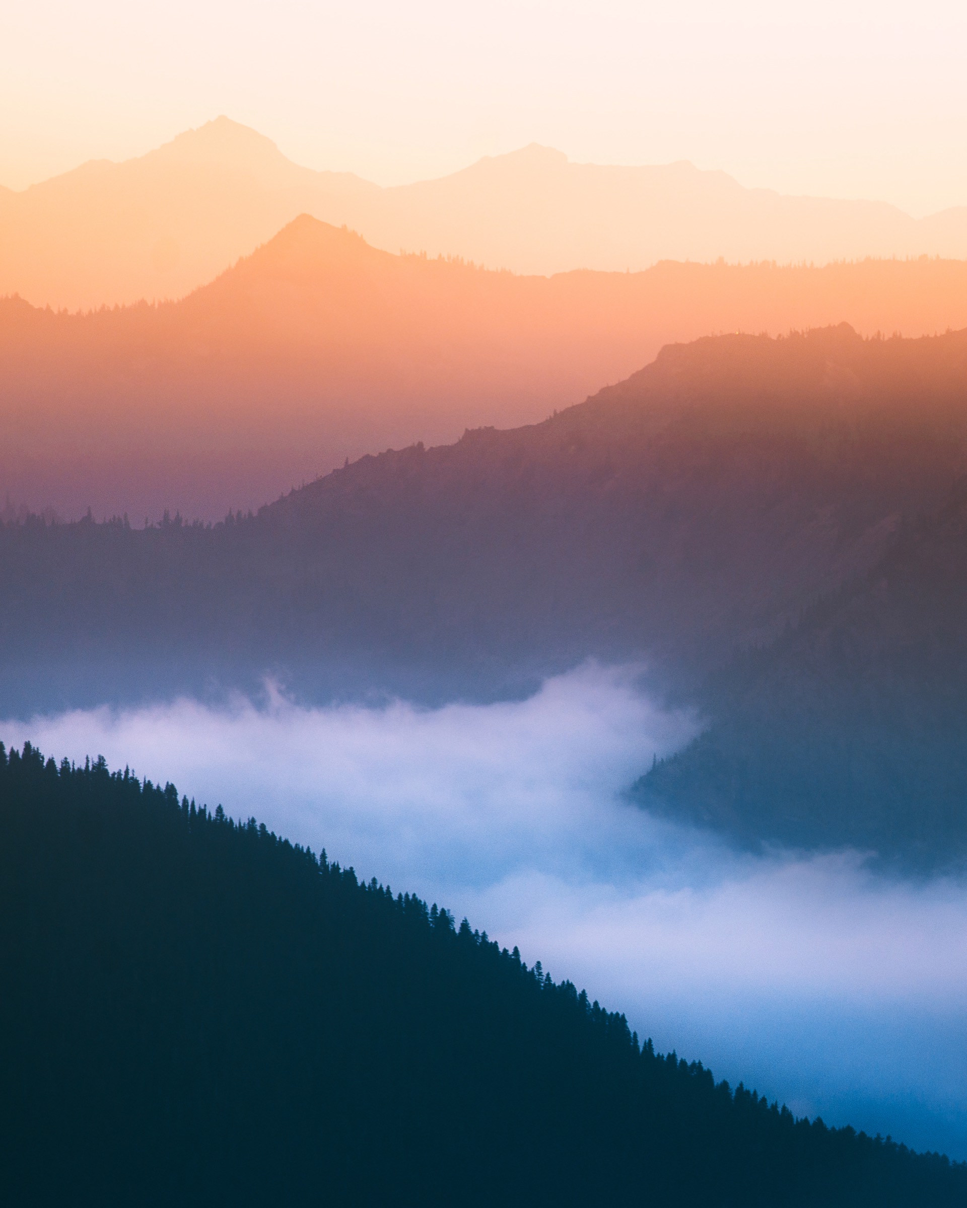 Blue ridgelines under shafts of evening light